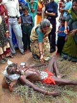 Devotees offer money to the 65-year-old 'Khanta Baba'