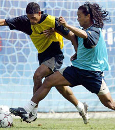 FC Barcelona�s new Brazilian recruit Ronaldinho battles for the ball with team-mate Michael Reiziger
