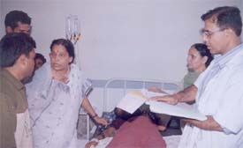 Dr Sudha Malaiya, member, National Commission for Women, visits a victim at Civil Hospital