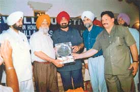 The Punjab DGP, Mr M.S. Bhular receives a plaque from Minister for Sports Jagmohan Singh Kang in Mohali 