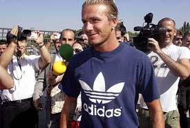 Real Madrid's latest recruit David Beckham is surrounded by reporters