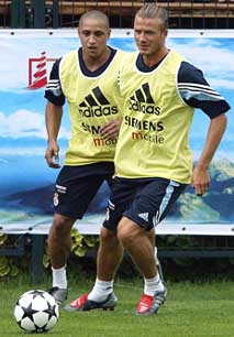 Real Madrid midfielder Beckham and defender Roberto Carlos practice at the Hongta Sports Centre