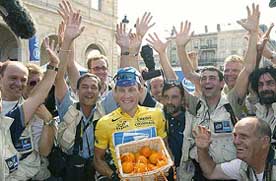 Lance Armstrong of the US poses with a basket of oranges 
