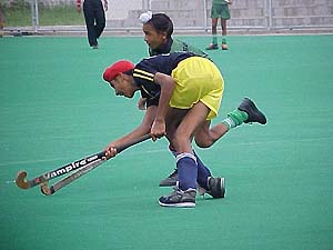 A keen tussle for the ball in the Mata Chanan Kaur Dhanoa Punjab Champion Hockey League 
