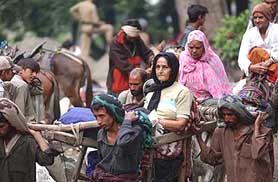 Porters carry pilgrims towards Amarnath