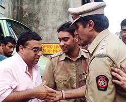 Amitabh Bachchan, Ajay Devgan and Raj Kumar Santoshi on the sets of �Khakhee� in Mumbai on Saturday. 