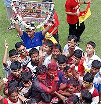 East Bengal supporters play with colours to celebrate the historic win of their club 