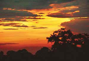 The setting sun casts an ethereal glow through rain clouds after the city was lashed by sharp showers on Monday