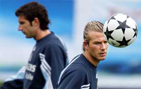 Real Madrid midfielder Beckham trains along with team-mate Luis Figo 