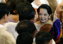 Philippine President Gloria Macapagal Arroyo greets legislators after delivering her state of the nation address in Manila on Monday.
