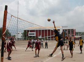 A volleyball match in progress between BCM School and Government School, Gobind Nagar, at KVM School