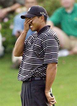 Tiger Woods reacts to another missed birdie putt on the 13th hole at the Battle At The Bridges