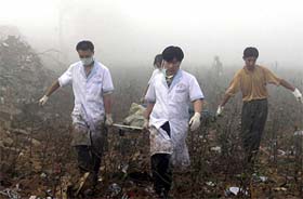 Rescue workers carry a wounded victim to the hospital at the blast site in Xinji City