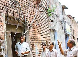 Exposed electric cables hang precariously at the rear end of SCO 264 in Sector 35-D, Chandigarh.