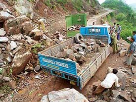 PWD men clear the road near Seelo Dhaulaghat in the Morni area on Wednesday.