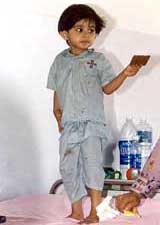 Two-year-old Noor Fatima from Pakistam, who underwent a successful heart surgery, plays on her bed in a Bangalore hospital 