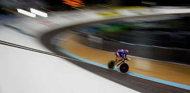 Great Britain's Bradley Wiggins races from a curve during the men's Individual Pursuit qualifying race