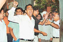 Supporters of Panjab University Students Union argue with the Chairman of the Law Department, Prof Bal Krishan, protesting against the assault on its president in Chandigarh, on Thursday. 