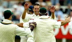 South African bowler Andy Hall celebrates the dismissal of England captain Michael Vaughan 