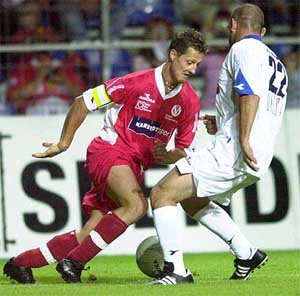 Formula One star Michael Schumacher of Team Sport fights for the ball against comedian Django Asyl of Team Show 