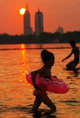 A girl cools off at the East Lake in Wuhan