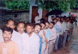 Residents brave the rain to get photographed for voters’ ID cards in Bhaura Colony, Ludhiana