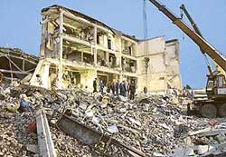 Emergency workers search the site of a bomb blast at a military hospital in the town of Mozdok in Russia’s Caucasus on Saturday