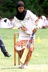 A Kashmiri student plays cricket at a tournament in Srinagar