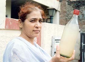 A resident shows a bottle of contaminated drinking water in Ludhiana
