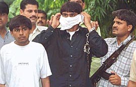 Members of Kishan Pahelwan gang, Pawan Malik in white and Rajesh Dahiya in blue, being produced by the Special Cell at Patiala House courts in the Capital on Saturday
