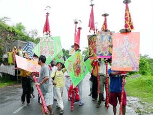 Devotees take out a procession  on the eve of Sawan Aashtami festival
