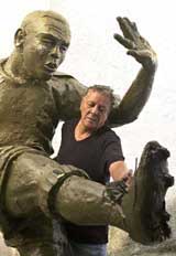 Sculptor Zygomar Bezerra da Silva shows a life-size statue of Brazilian soccer star Ronaldo