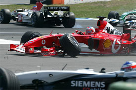 Brazil's Ferrari driver Rubens Barrichello and Finland's McLaren Mercedes driver Kimi Raikkonen sit in their damaged cars after they crashed in the first corner of the German Grand Prix