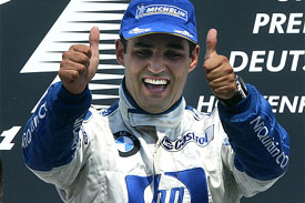 Williams BMW's Columbian driver Juan Pablo Montoya flashes a double thumbs-up sign after winning the German Grand Prix 