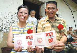 Bridegroom Cao Xueliang and his 34-year-old bride Wang Daiying show their marriage certificate