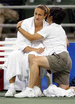 Mary Pierce of France is being attended by a trainer during her match against Tamarine Tanasugarn of Thailand 