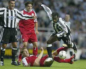 Newcastle United's Oliver Bernard battles for the ball with Bayern Munich's Bastian Schweinsteiger
