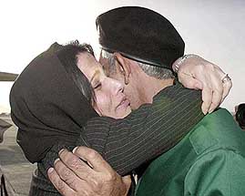 Shakilah Istalefi hugs her elder brother Ahmad Zia after their meeting at the Kabul International airport