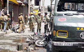 Two-wheelers lie on the road beside a BSF vehicle which was damaged in a grenade attack by militants at Lal Chowk in Srinagar on Thursday.