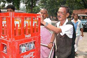 Canteen staff remove the remaining stock of soft drinks from the Parliament House on Thursday.