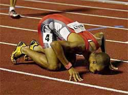 Felix Sanchez of the Dominican Republic kisses the track after winning the 400m hurdles at the Pan American Games 