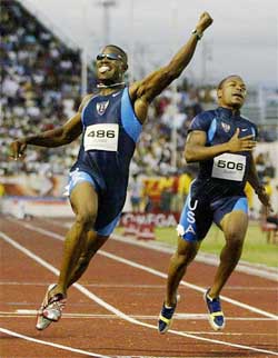 Mickey Grimes (L) of the US sprints to win the men's 100m final at the XIV Pan American Games