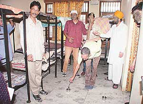 Inmates of the Amarjot Drug De-addiction Centre �re-enact� one of the many forms of torture they were allegedly subjected to by Director Amar Bedi at Phase IX, SAS Nagar, on Friday.