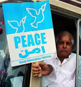 Laloo Prasad Yadav holds a placard after crossing into Pakistan at the Wagah border near Lahore