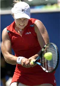Kim Clijsters of Belgium hits a backhand return during her 6-3, 6-1 quarterfinal victory over Russia's Svetlana Kuznetsova
