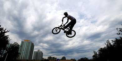 A Chinese youth flies through the air on his bicycle at an extreme sports competition