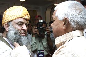 Fazl-ur-Rehman, a central leader of Pakistan's main hardline Islamic alliance, greets Laloo Prasad Yadav in Islamabad on Sunday.