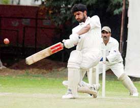 Jan Mohammad drives the ball over covers