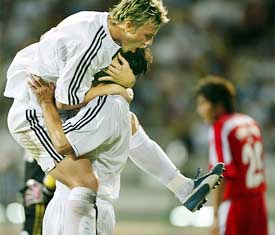 Real Madrid's Jose Maria Guti embraces teammate Fernando Morientes after the latter scored the decisive second goal