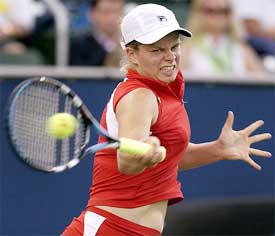 Top seed Kim Clijsters of Belgium hits a forehand return to Italy's Francesca Schiavone